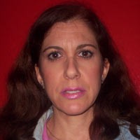 Lillie Cain Frowning woman with long dark hair